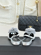 Chanel slingback sandals with silver metallic finish and white flower strap accents