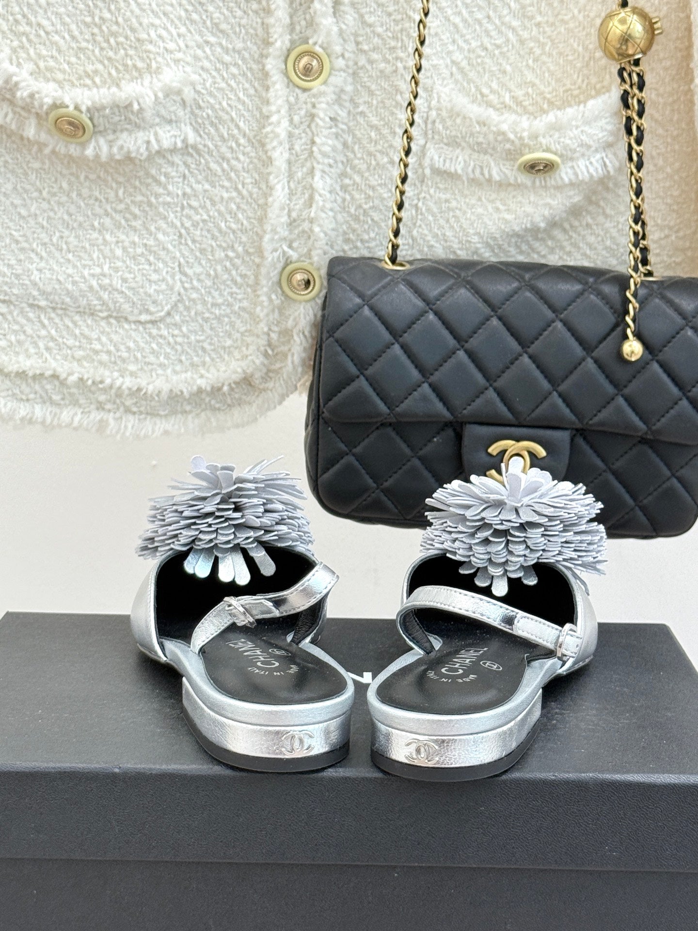 Chanel slingback sandals with silver metallic finish and white flower strap accents