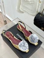 Two-tone slingback flats with white flower appliques on gold toes