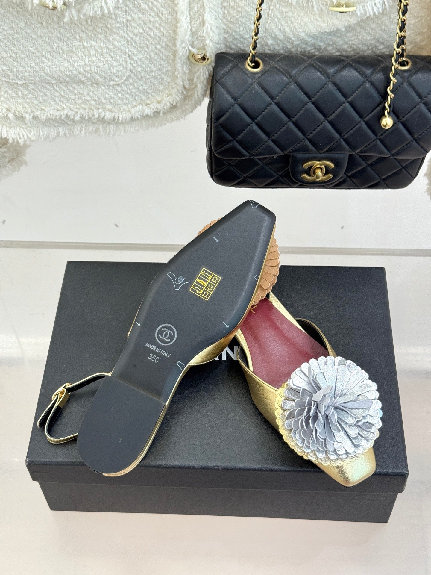 Gold mule flats with white flower appliques and burgundy “CHANEL” lining
