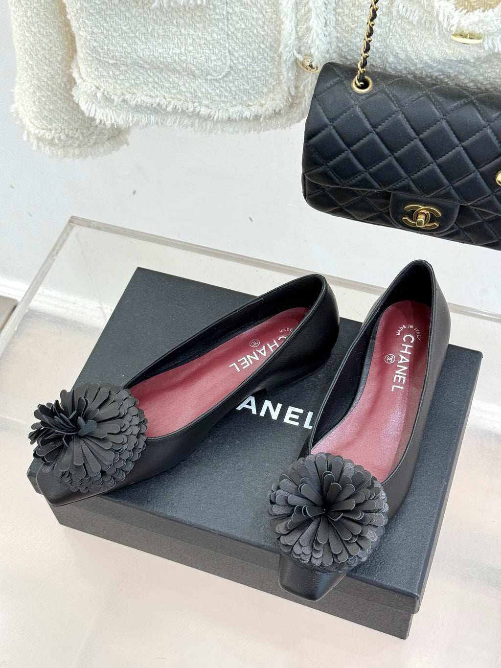 Chanel dark flats with red interior lining and gray flower bow detail
