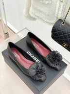 Chanel dark leather flats with gray flower rosette on top