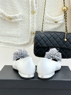 White women's flats with 3D flower appliques, back view of the heel and toe