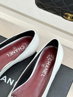 White Chanel flats with 'Made in France' text on the inner insole