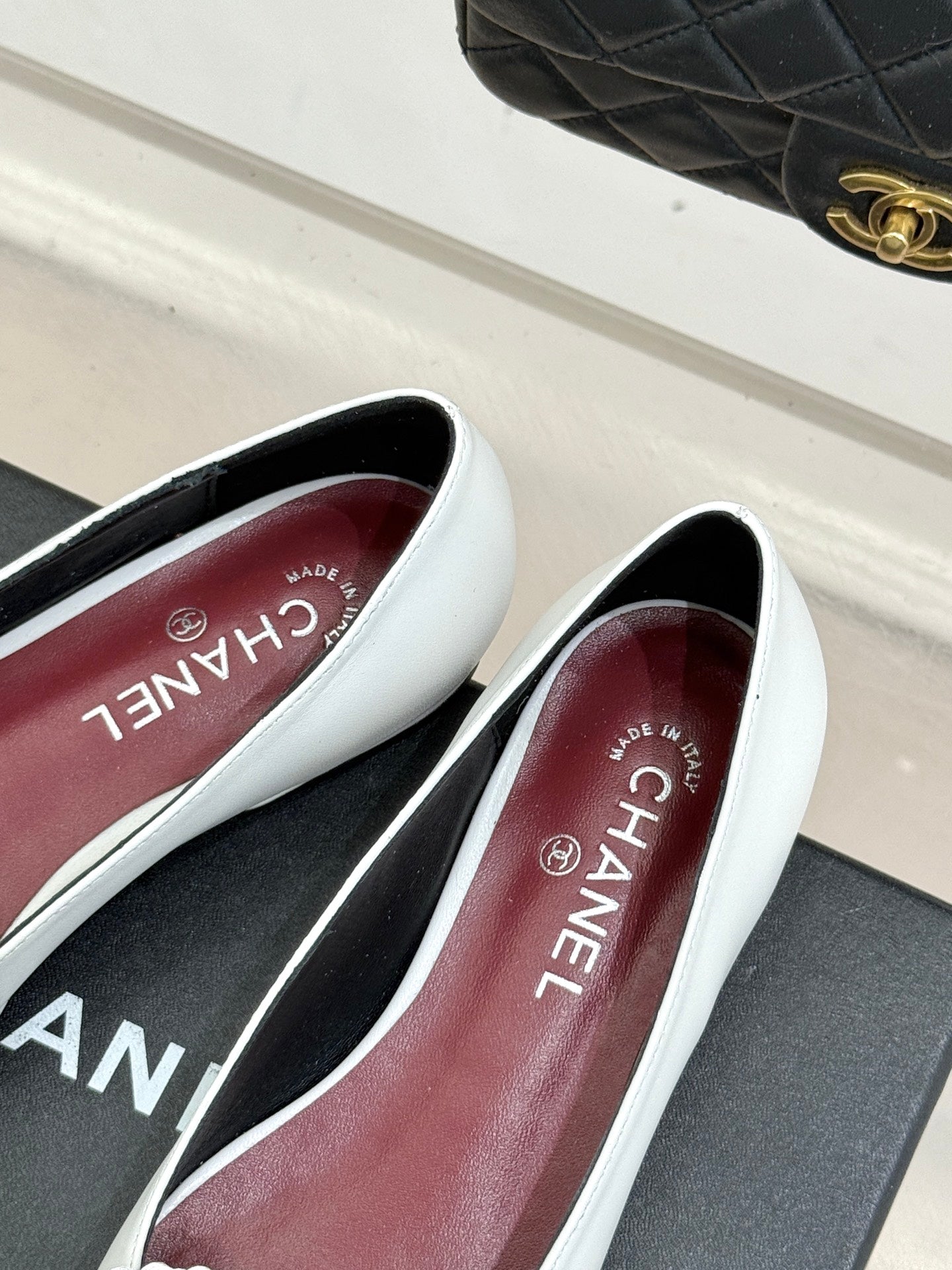 White Chanel flats with 'Made in France' text on the inner insole