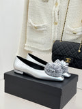 Chanel ladies silver ballet flats with quilted toe, white flower detail, flat heel