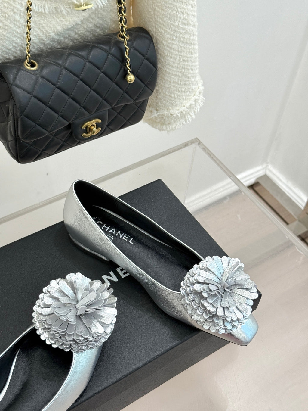 Chanel ladies silver slip-on flats with white flower ornaments on the toe