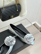 Chanel ladies silver slip-on flats with white flower ornaments on the toe