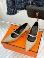 Cream pointed pumps with black lining and slim strap detail