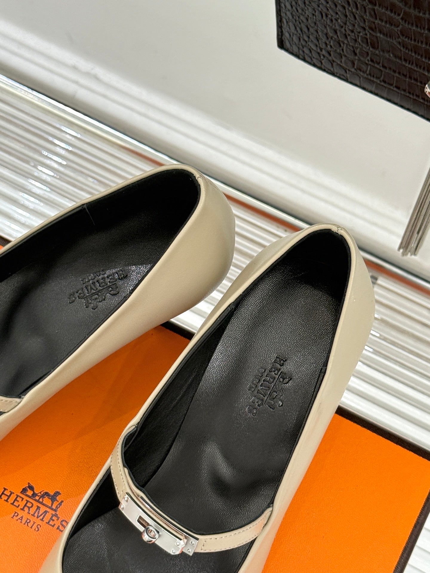 Cream pointed pumps with black insoles and ankle-sling strap
