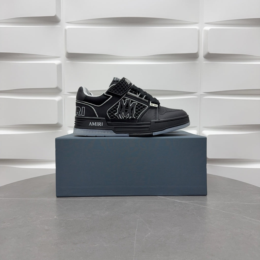 Luxury low-top sneakers in black with AMIRI branding and patterned side logo
