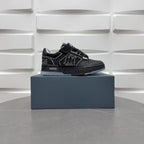 Luxury low-top sneakers in black with AMIRI branding and patterned side logo