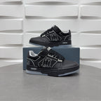 Pair of black low-top sneakers on blue boxes with lace strap and side emblem