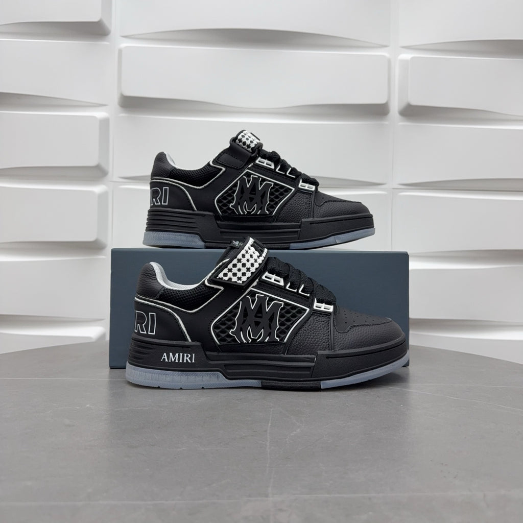 Pair of black low-top sneakers with checkerboard strap and graphic logo, on box.