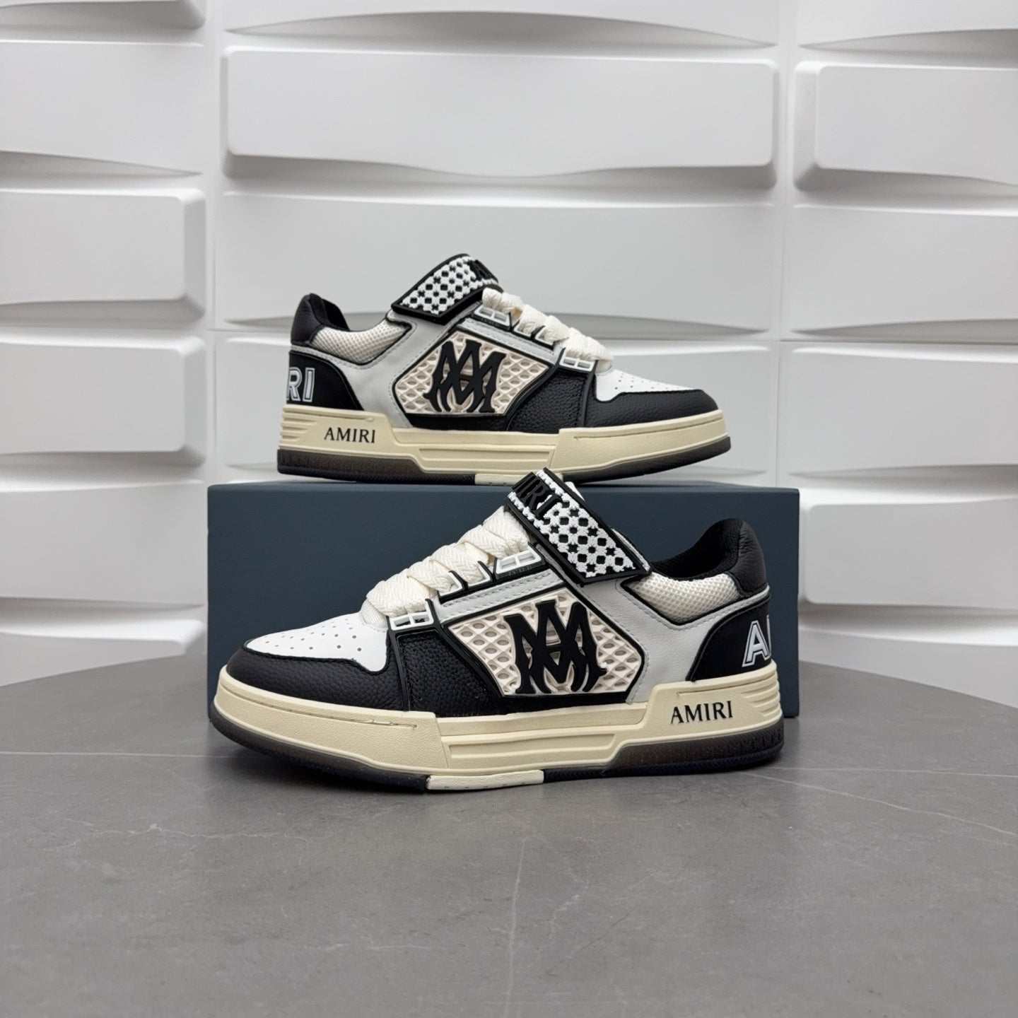 Black and white low-top sneakers with checkered strap, lace-up, beige sole.