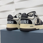 Pair of black and white sneakers with checker trim, AMIRI logo, beige sole.