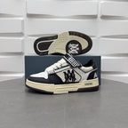 Sneaker outsole and side profile, black and white upper, checkered strap, beige sole.
