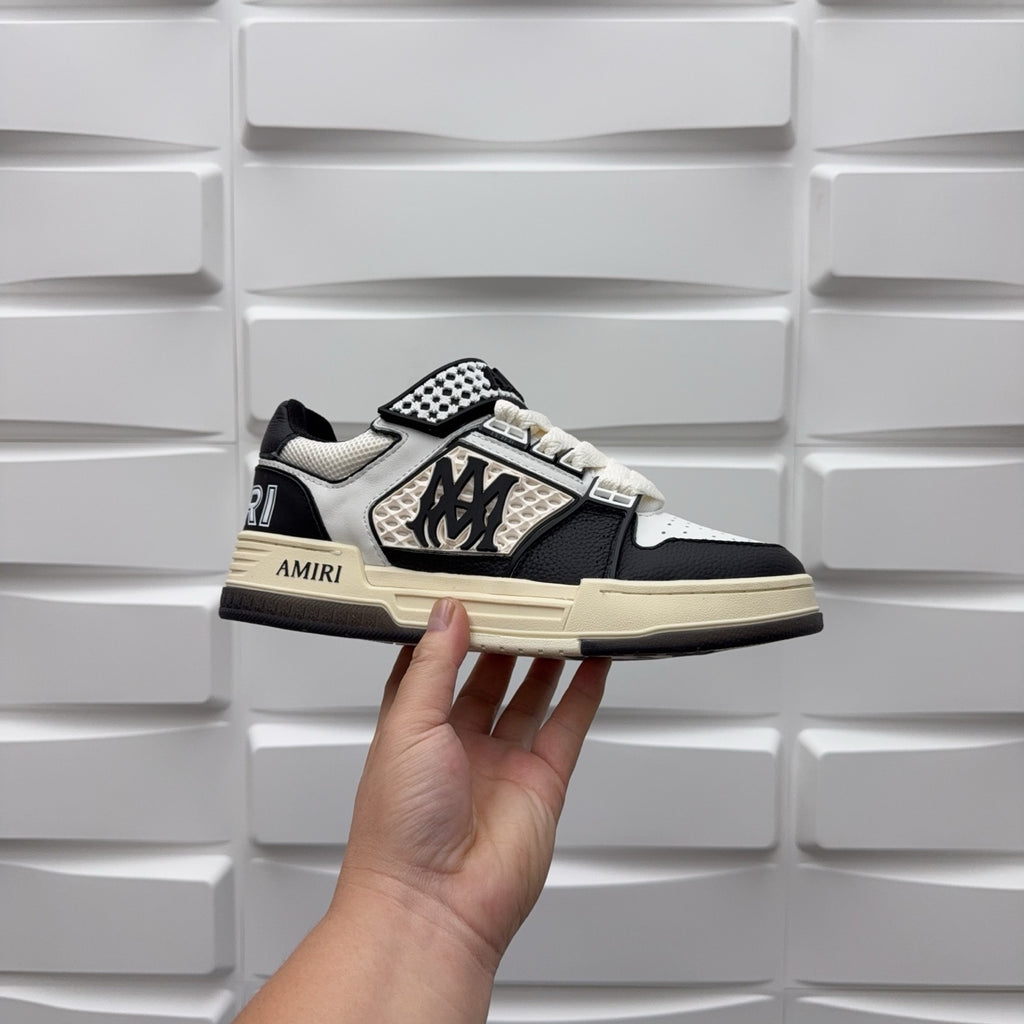 Black and white low-top sneakers, checker strap and lace-up, beige midsole.