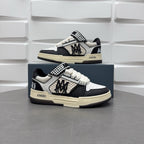 Pair of black and white sneakers, checkered strap and lace-up, beige sole.