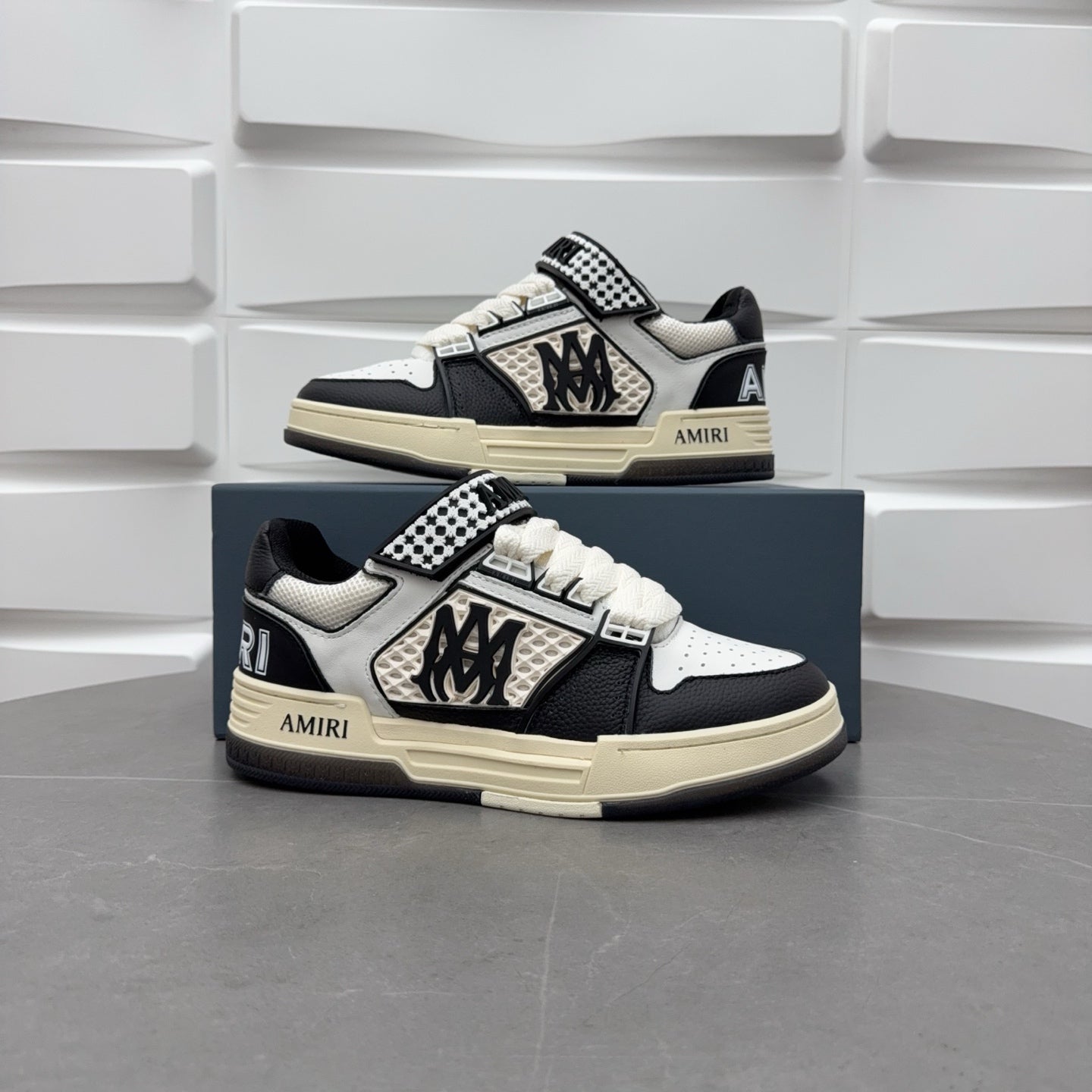Pair of black and white sneakers, checkered strap and lace-up, beige sole.