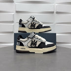 Pair of black and white low-top sneakers, checker strap, lace-up, beige sole.