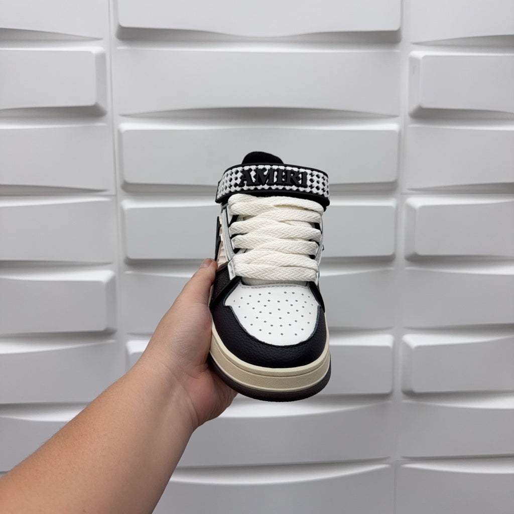 Low-top sneakers heel view, black and white with checkered strap, beige sole.