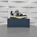 Black and white low-top sneakers with checker strap, lace-up, beige sole.