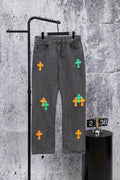 Dark gray denim pants with colorful cross patches on the front legs