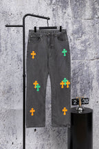 Dark gray denim pants with colorful cross patches on the front legs