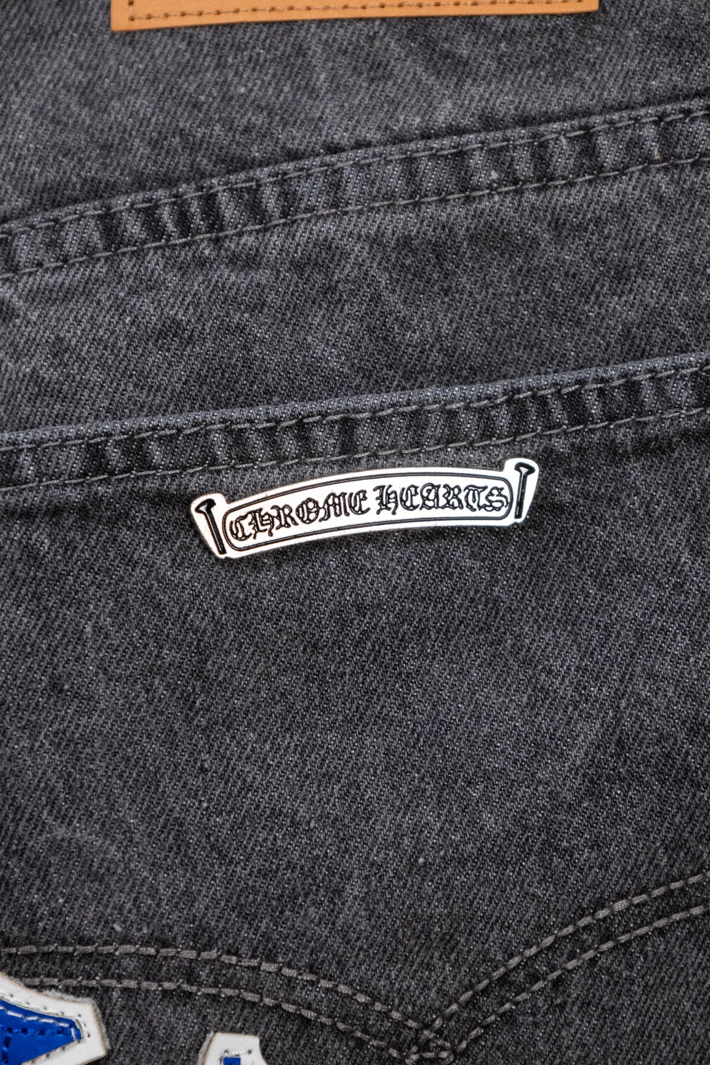 Chrome pants pocket label detail with logo tag and orange trim