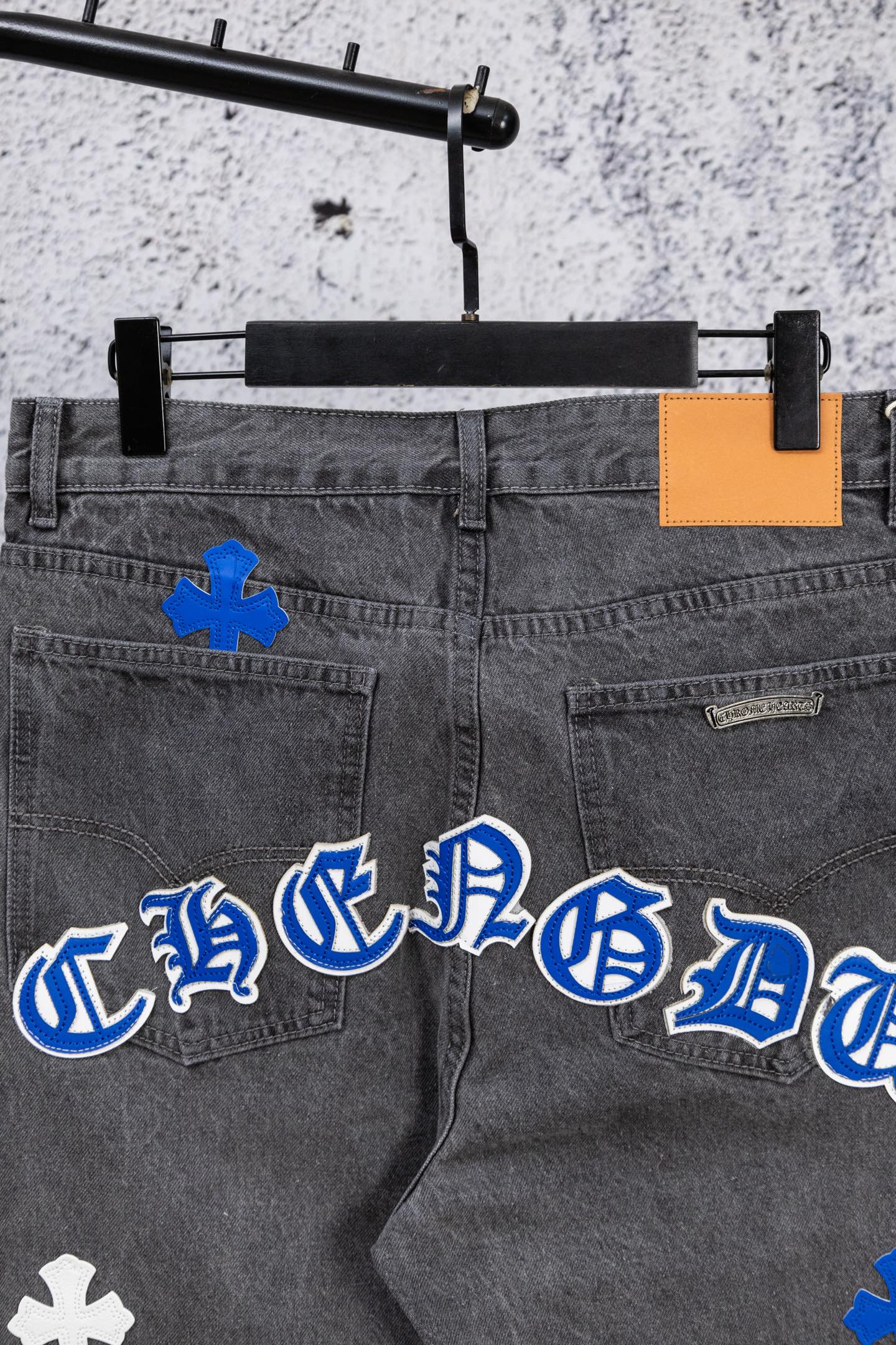 Chrome pants in dark denim with blue and white cross applique front
