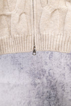 Cream ribbed knit sweater with center-front zipper and textured cable pattern