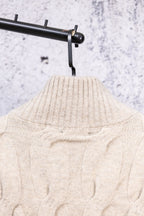 Cream knit sweater neckline and cable pattern, stand collar view