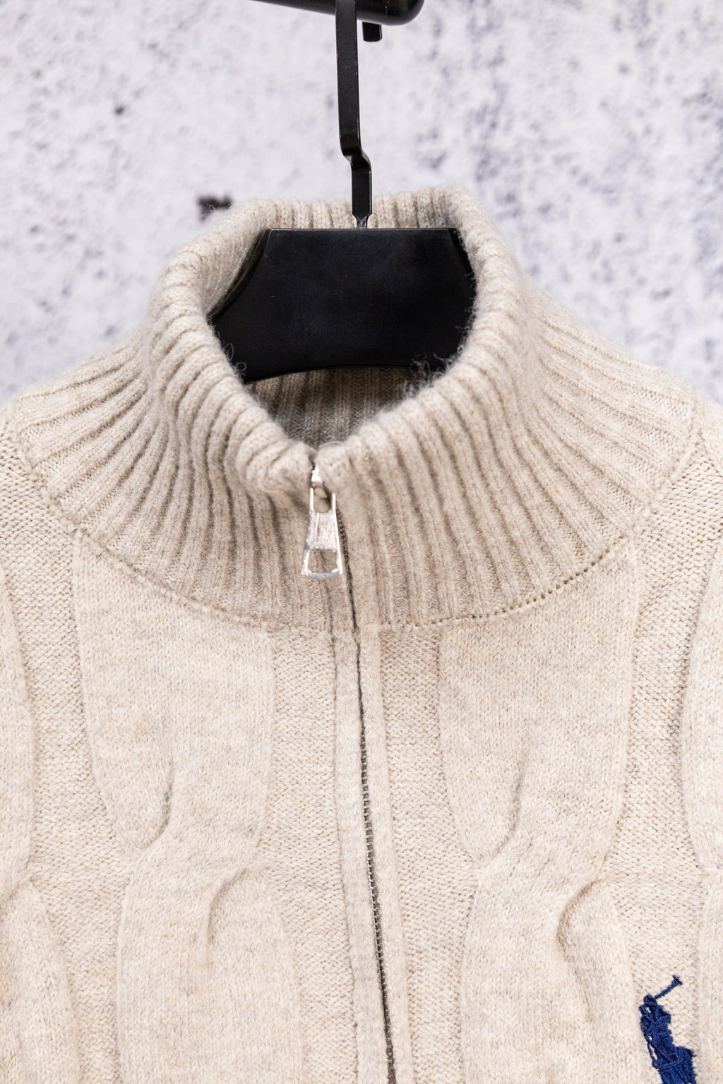 Cream ribbed stand-collar knit sweater with center-front zipper