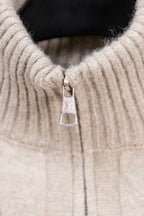 Cream knit sweater with stand collar and metal zipper pull detail