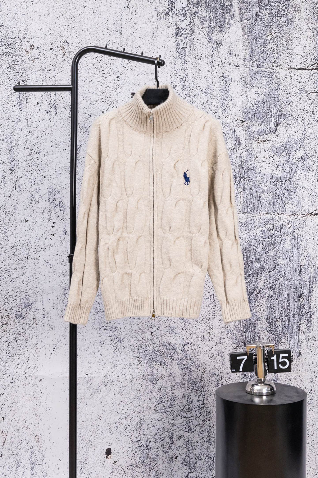 Cream knit zip-up sweater with stand collar and small blue polo logo
