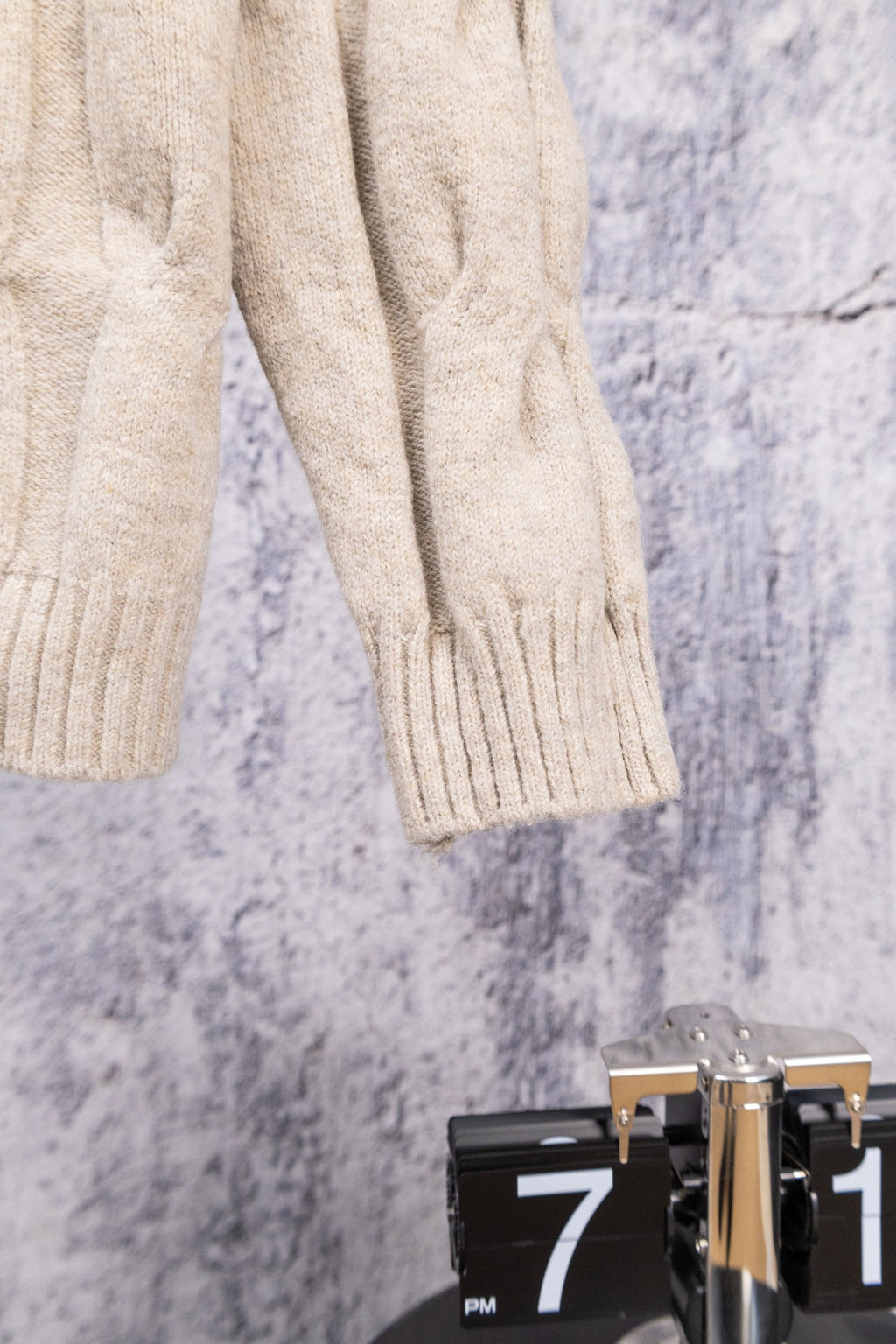 Cream knit zip-up sweater sleeve and hem with ribbed cuffs
