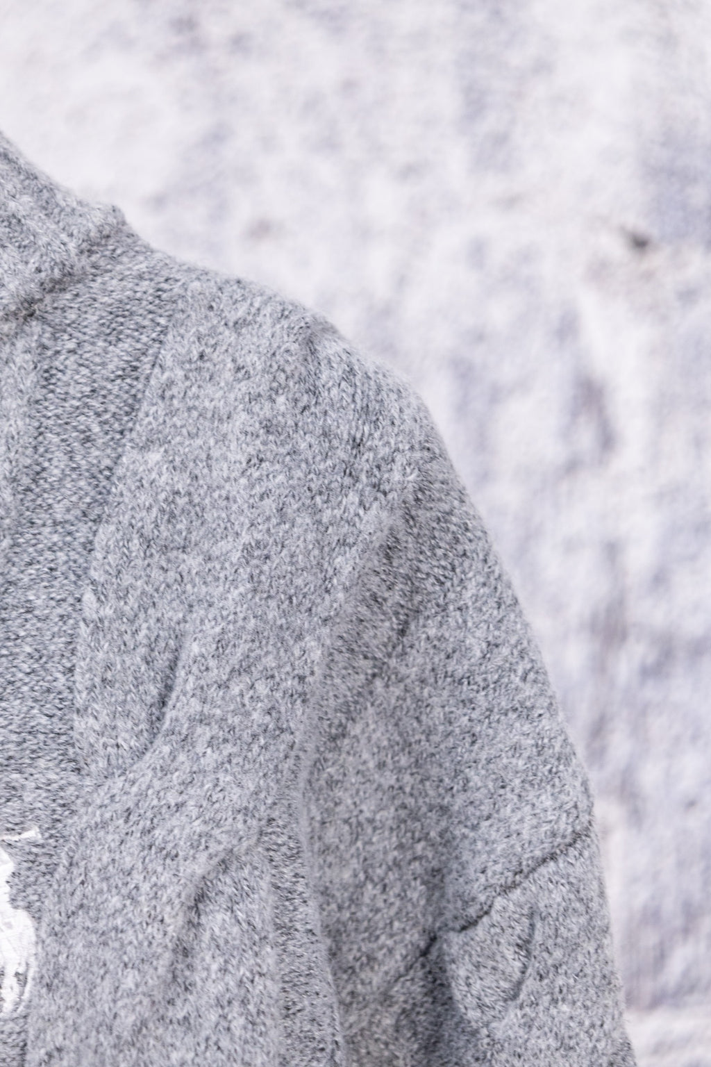 Heather gray knit sweater shoulder and sleeve seam detail
