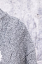 Heather gray knit sweater shoulder and sleeve seam detail