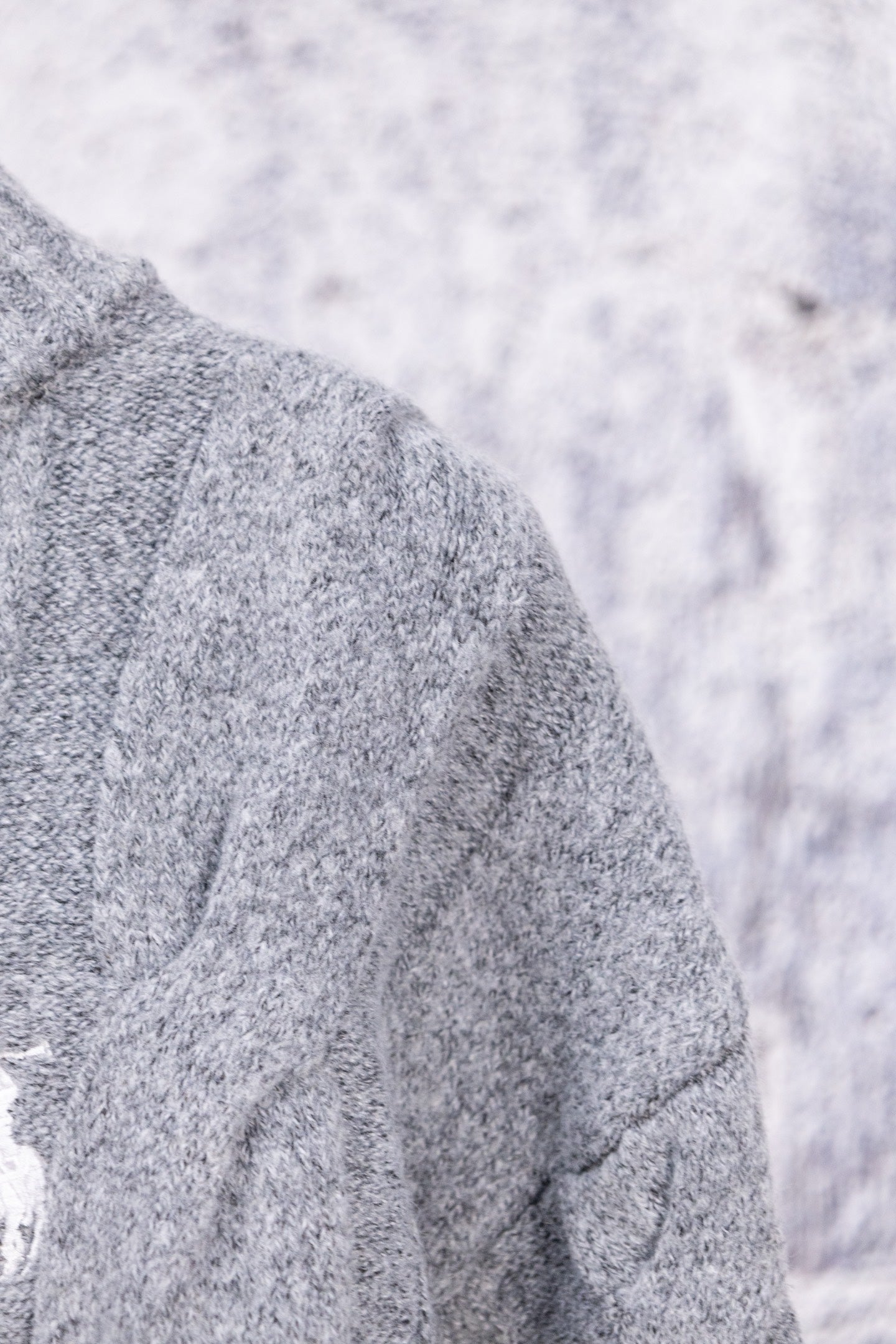 Heather gray knit sweater shoulder and sleeve seam detail