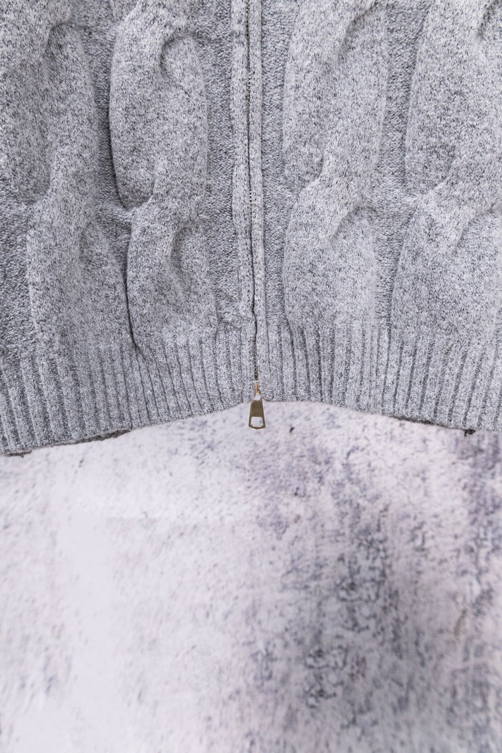 Heather gray knit sweater back hem with half-zip pull tab
