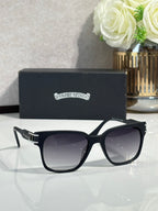 Black oversized sunglasses with dark lenses and engraved side logo