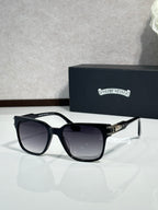 Black oversized sunglasses with dark lenses and metal hinge details