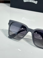 Close-up of black sunglasses with dark-tinted lens and temple arm