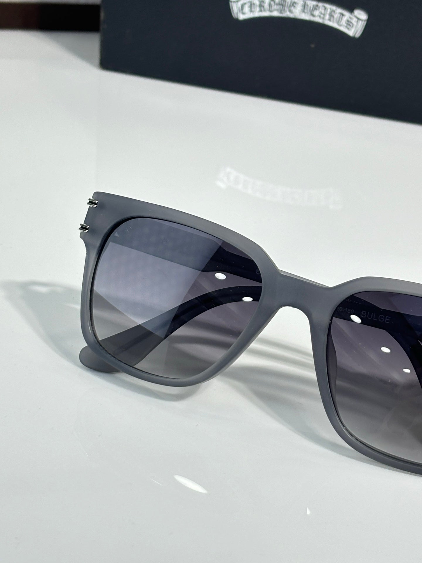 Close-up of black sunglasses with dark-tinted lens and temple arm