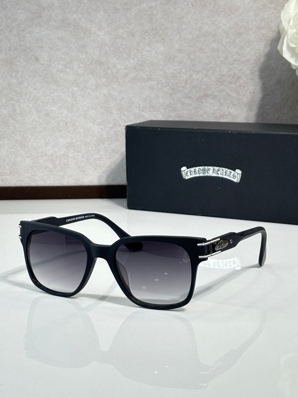 Front view black oversized sunglasses with dark lenses and logo temples
