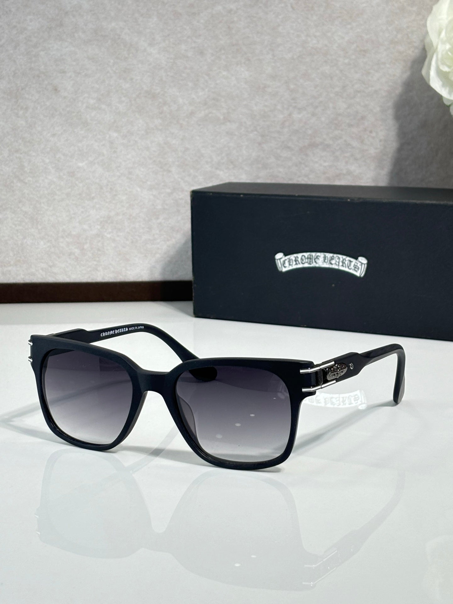Front view black oversized sunglasses with dark lenses and logo temples
