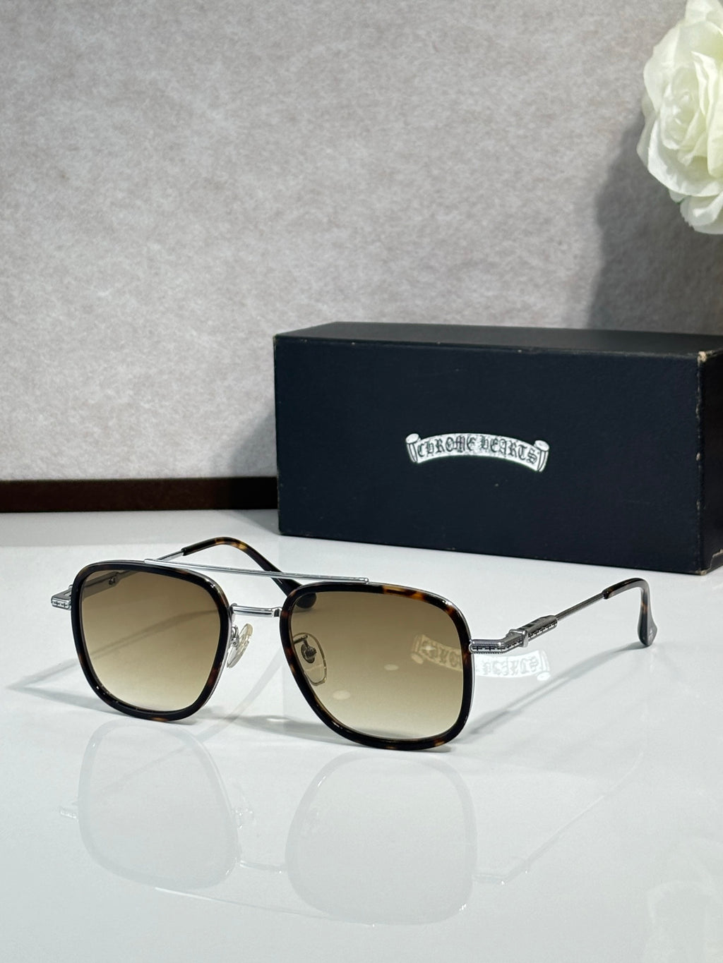 Metal-frame sunglasses with brown-tinted lenses and black frame edges