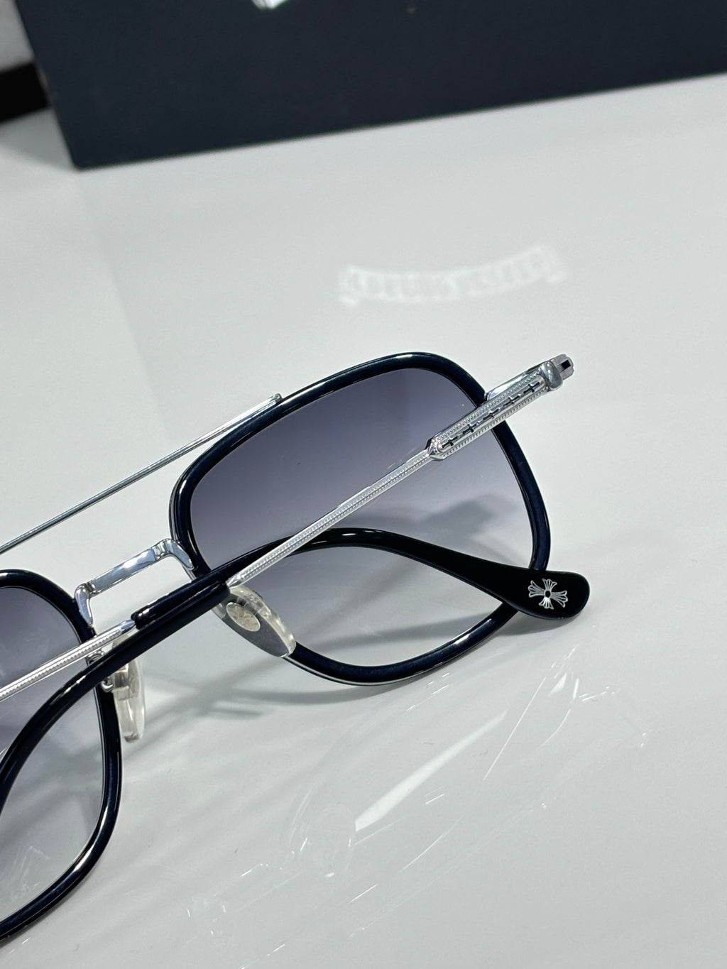 Metal-frame sunglasses with dark lenses and curved temple arms