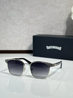 Sunglasses with dark lenses, black frame, chrome temple detail and logo